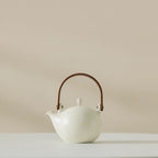 Théière Blanche Japonaise en Porcelaine sur un fond beige 