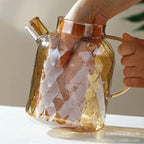 Théière en Verre Borosilicate Texturé main qui met sa main dans la théière 